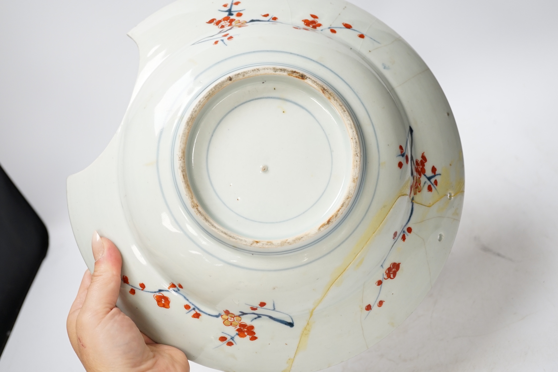 A Japanese Arita ‘cranes and chicks’ barber's bowl, early 18th century, in Imari palette, 27.5cm diameter. Condition - poor (a.f.)